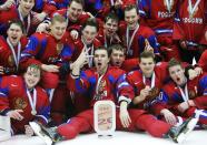 Russia's Nikita Tryamkin (C) and his teammates celebrate after defeating Canada to win the bronze medal after their IIHF World Junior Championship ice hockey game in Malmo, Sweden, January 5, 2014. REUTERS/Alexander Demianchuk (SWEDEN - Tags: SPORT ICE HOCKEY)