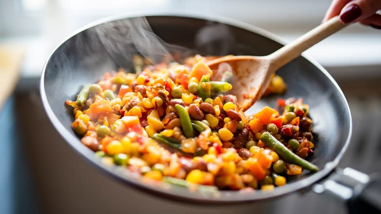 stirring beans in pan