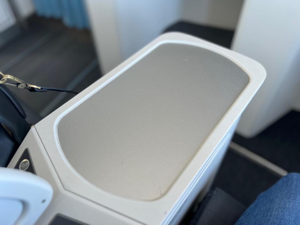 Flying on La Compagnie all-business class airline from Paris to New York — tabletop between the loungers.