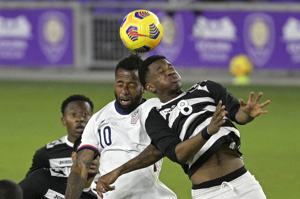 FILE - United States midfielder Kellyn Acosta (10) and Trinidad and Tobago midfielder Andre Fortune (8) battle for a header during the first half of an international friendly soccer match in Orlando, Fla., in this Sunday, Jan. 31, 2021, file photo. U.S. Soccer, Major League Soccer and the National Women's Soccer League are joining a trial program that will allow teams two additional substitutes for suspected concussions in each match. (AP Photo/Phelan M. Ebenhack, File)