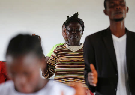 Churchgoers pray at a church where evangelist and ex-combatant Joshua Milton Blahyi preaches in Grand Gedeh, Liberia, July 3, 2016. REUTERS/Thierry Gouegnon