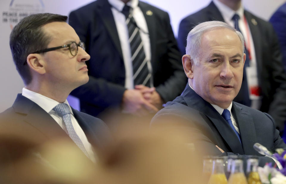 File -- In this Thursday, Feb. 14, 2019 photo Poland's Prime Minister Mateusz Morawiecki, left, and Israeli Prime Minister Benjamin Netanyahu, right, attend a meeting in Warsaw, Poland. Poland's prime minister canceled plans for his country to send a delegation to meeting in Jerusalem on Monday after the acting Israeli foreign minister Israel Katz said that Poles "collaborated with the Nazis" and "sucked anti-Semitism from their mothers' milk". (AP Photo/Michael Sohn)
