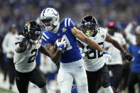 Indianapolis Colts wide receiver Michael Pittman Jr., center, runs with the ball after catching a 39-yard pass for a touchdown as Jacksonville Jaguars safety Rayshawn Jenkins (2) and Tyson Campbell (32) defend during the second half of an NFL football game Sunday, Sept. 10, 2023, in Indianapolis. (AP Photo/Darron Cummings)