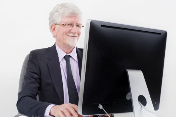 senior businessman with computer over white