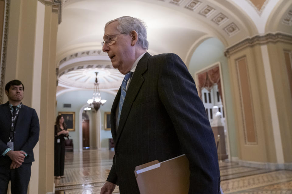 Senate Majority Leader Mitch McConnell, R-Ky., walks to the chamber as lawmakers negotiate on the emergency coronavirus response legislation, at the Capitol in Washington, Wednesday, March 18, 2020. (AP Photo/J. Scott Applewhite)