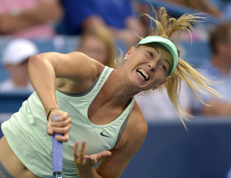 Maria Sharapova, from Russia, serves during a match against Sloane Stephens, from the United States, at the Western & Southern Open tennis tournament, Tuesday, Aug. 13, 2013, in Mason, Ohio. (AP Photo/Michael E. Keating)