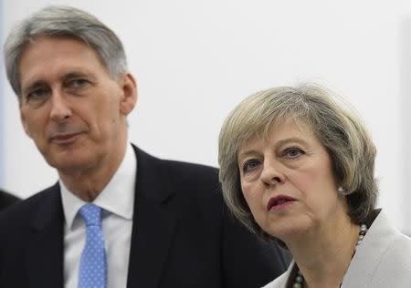 Britain's Prime Minister Theresa May and Chancellor of the Exchequer Philip Hammond tour the Renishaw innovation and engineering plant in Wootton, south west England, in Britain, November 24, 2016. REUTERS/Toby Melville