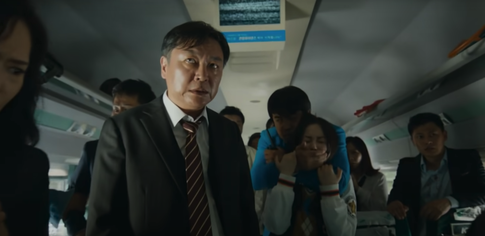 Kim Eui-sung as Yong-suk stares at survivors begging for help in "Train to Busan"