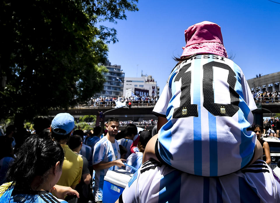 BUENOS AIRES, ARGENTINA - DECEMBER 20: A fan on Argentina wears a jersey of Lionel Messi as a multitude celebrate near 25 de Mayo highway for the victory parade of the Argentina men's national football team after winning the FIFA World Cup Qatar 2022 on December 20, 2022 in Buenos Aires, Argentina. (Photo by Marcelo Endelli/Getty Images)