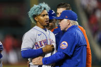 New York Mets shortstop Francisco Lindor, left, is pulled from the game by manager Buck Showalter, right, after he was hit by a pitch during the fifth inning of a baseball game against the Washington Nationals at Nationals Park, Friday, April 8, 2022, in Washington. (AP Photo/Alex Brandon)