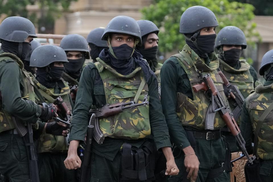 Army soldiers stand guard following an eviction of protesters from the presidential secretariat in Colombo, Sri Lanka, Friday, July 22, 2022. (AP Photo/Eranga Jayawardena)