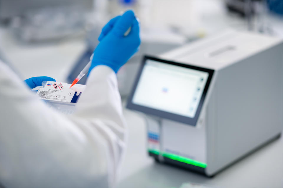 HILDEN, GERMANY - MARCH 11: An employee of German biotech company Qiagen demonstrates the use of the Qiagen QIAstat-Dx testing device for infectious diseases at the Qiagen plant on March 11, 2020 in Hilden, Germany. Qiagen has modified the device for testing fluid samples for coronavirus infection and Qiagen is seeking to deliver it to hospitals, clinics and doctors across Europe. Germany has registered approximately 1,200 cases of coronavirus infection and recently reported its first two deaths. (Photo by Sascha Schuermann/Getty Images)