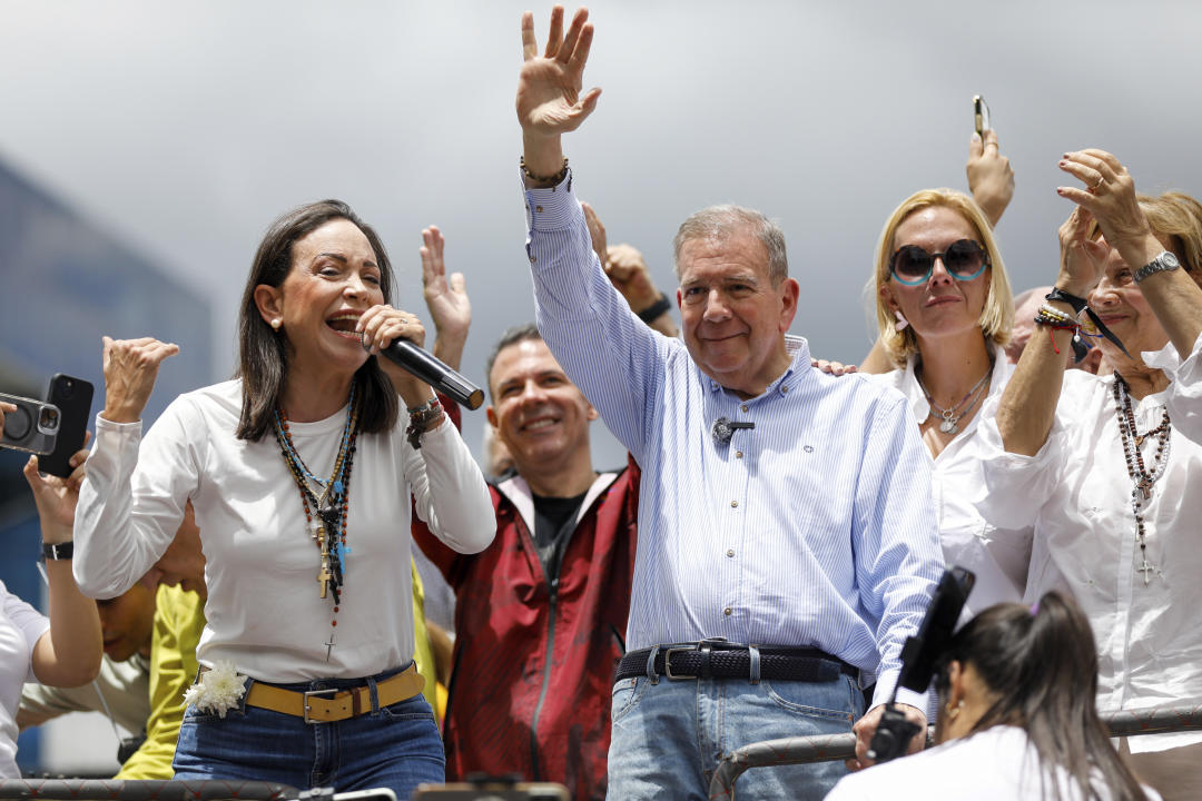 Opposition leader Maria Corina Machado, left, and opposition presidential candidate Edmundo Gonzalez address supporters from the top of a truck during a protest against the official presidential election results declaring President Nicolas Maduro the winner in Caracas, Venezuela, on Tuesday, July 30, 2024, two days after the vote. (AP Photo/Cristian Hernandez)