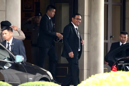 Thailand's Prime Minister Prayuth Chan-ocha waves as he leaves at the Government House in Bangkok