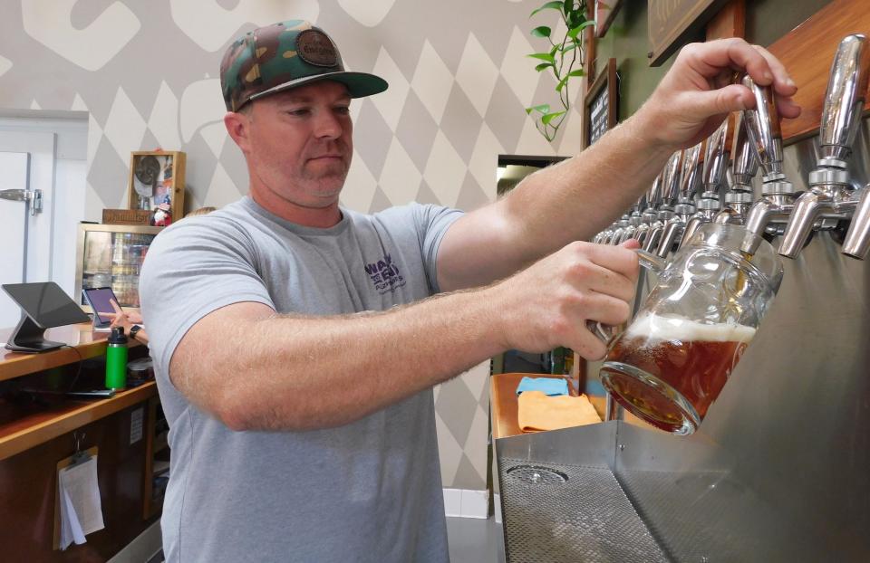 Chris Bird, co-owner of Enegren Brewing Co. in Moorpark, pours himself a lager Thursday.