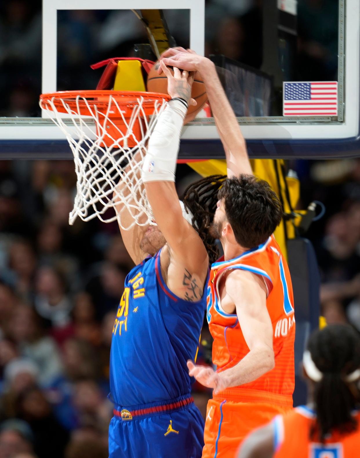 Oklahoma City Thunder forward Chet Holmgren, right, blocks a shot by Denver Nuggets forward Aaron Gordon in the second half of an NBA basketball game Saturday, Dec. 16, 2023, in Denver. (AP Photo/David Zalubowski)