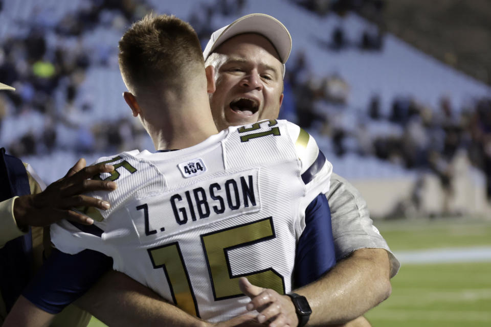 Georgia Tech interim head coach Brent Key, right, celebrates with quarterback Zach Gibson (15) after the team upset North Carolina in an NCAA college football game, Saturday, Nov. 19, 2022, in Chapel Hill, N.C. (AP Photo/Chris Seward)