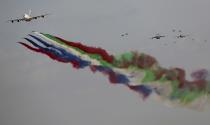 An Emirates Airline A-380 leads the "Al Fursan", or the Knights, a UAE Air Force aerobatic display team and a group of military planes during the opening day of the Dubai Airshow, in Dubai, United Arab Emirates, Sunday, Nov. 17, 2019. The biennial airshow opened as major Gulf airlines rein back big-ticket purchases after a staggering $140 billion in new orders were announced at the 2013 show before global oil prices collapsed. (AP Photo/Kamran Jebreili)