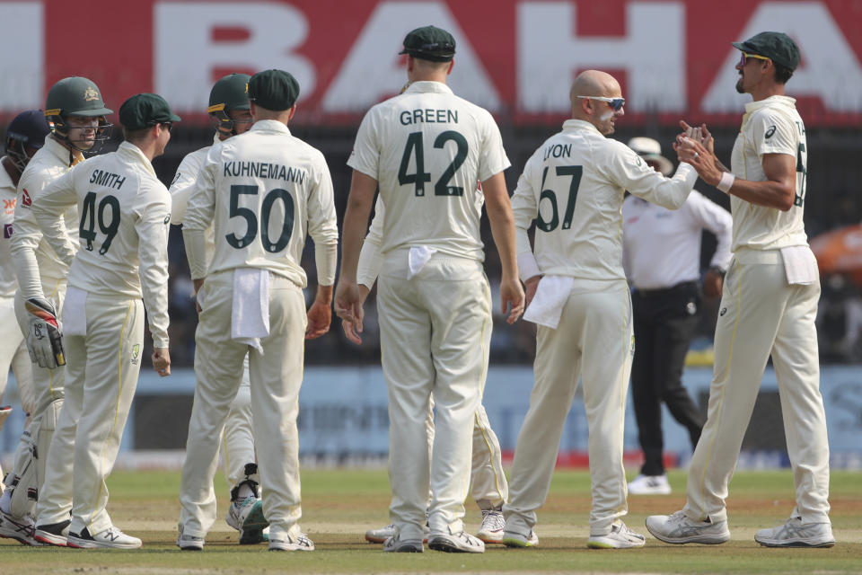 Australia's Nathan Lyon, second right, celebrates with his teammates the dismissal of India's Cheteshwar Pujara during the first day of third cricket test match between India and Australia in Indore, India, Wednesday, March 1, 2023. (AP Photo/Surjeet Yadav)