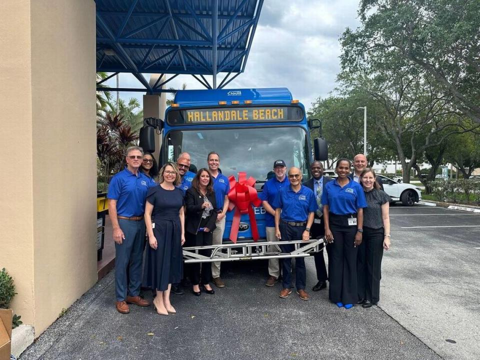 Staff from the City of Hallandale Beach stand in front of one of the nine electric buses the city purchased with the help of a Florida Department of Transportation grant.