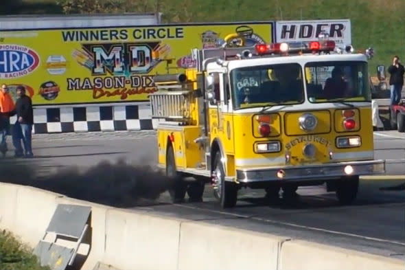 Fire engine pulls burnout on drag strip