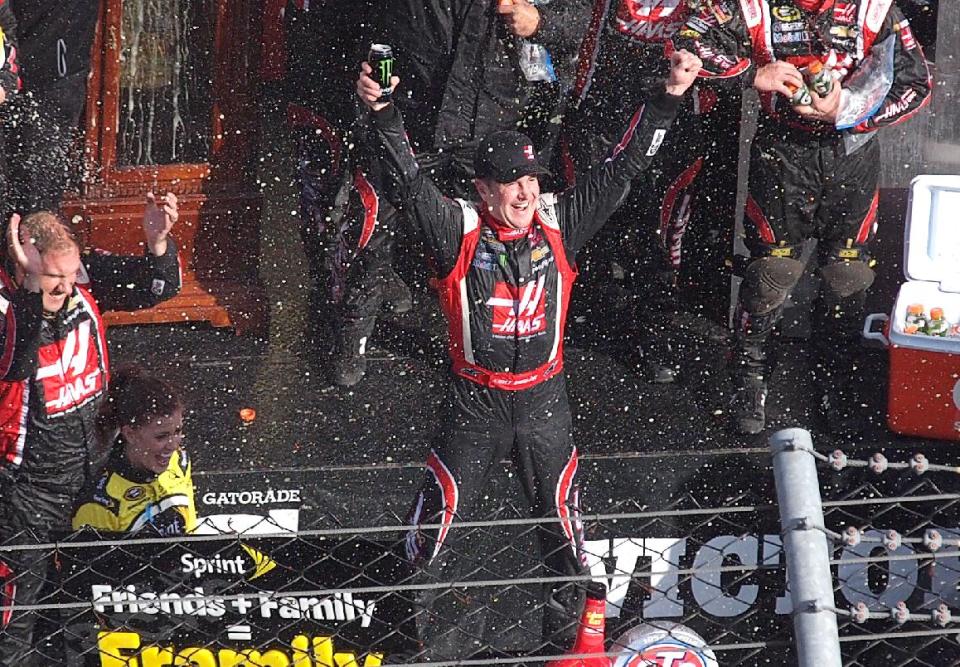 Driver Kurt Busch celebrates in victory lane after winning a NASCAR Sprint Cup auto race at Martinsville, Speedway in Martinsville, Va., Sunday March 30, 2014. (AP Photo/Steve Shappard)