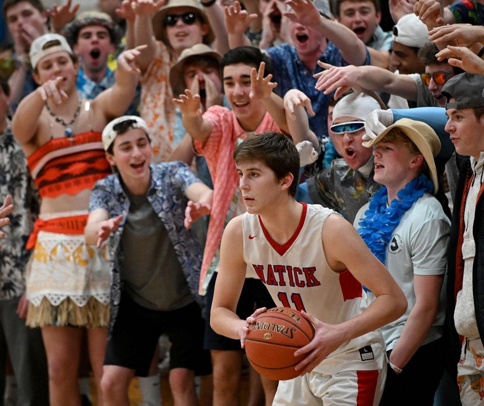 Natick's Ryan Mela has to contend with the Franklin student section as he inbounds the ball during the second half of the Division 1 Central quarterfinal game at Natick High School on  Feb. 27, 2020.