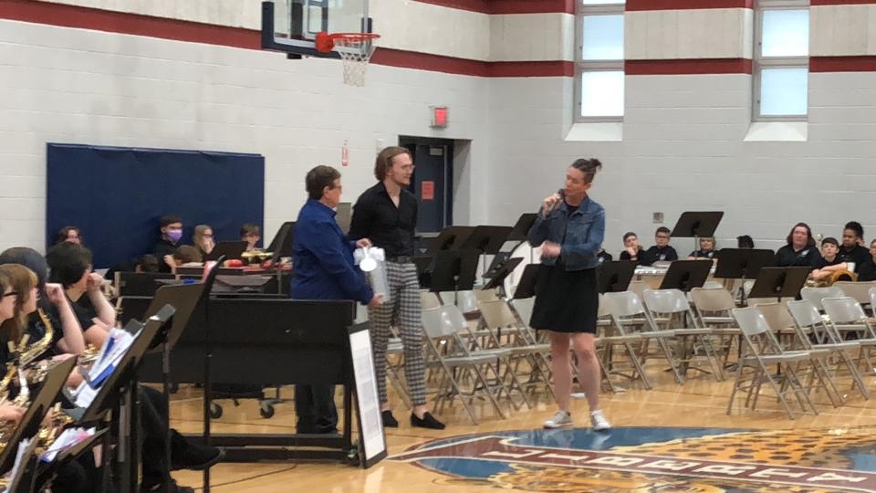 Brandy Frias (right) and her son, Austin (center) inform retiring Liberty Middle School band director Diana Wightman that a music scholarship in her name is being started for Newark City Schools.