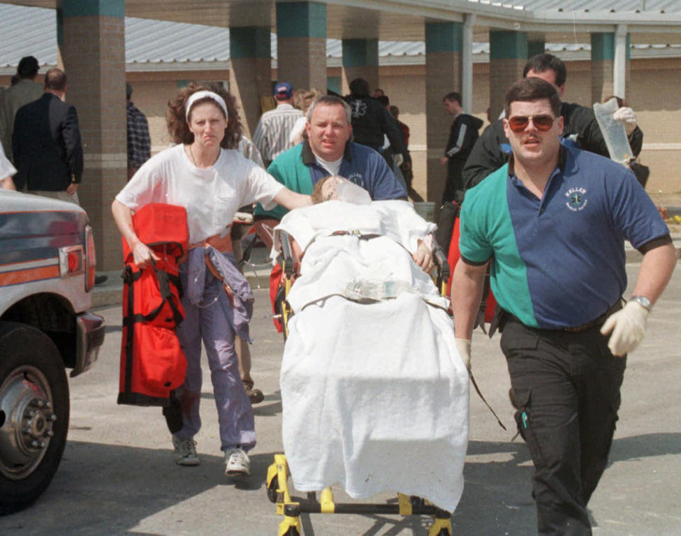 Emergency personnel rush an unidentified student to an ambulance at Westside Middle School