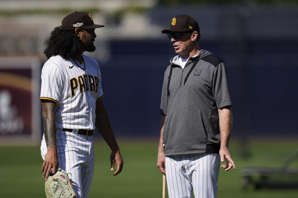 San Diego Padres pitcher Sean Manaea, left, talks with manager Bob Melvin during practice ahead of Game 1 of the baseball NL Championship Series against the Philadelphia Phillies, Monday, Oct. 17, 2022, in San Diego. The Padres host the Phillies for Game 1 Oct. 18. (AP Photo/Gregory Bull)