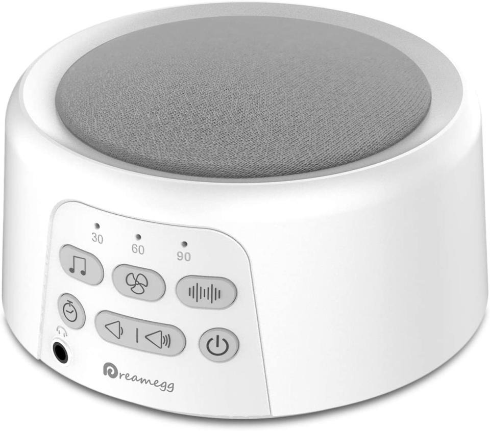 A white circular speaker and player with grey speaker fabric on top and controls on the side. Dreamegg D3 White Noise Machine, $69.99 