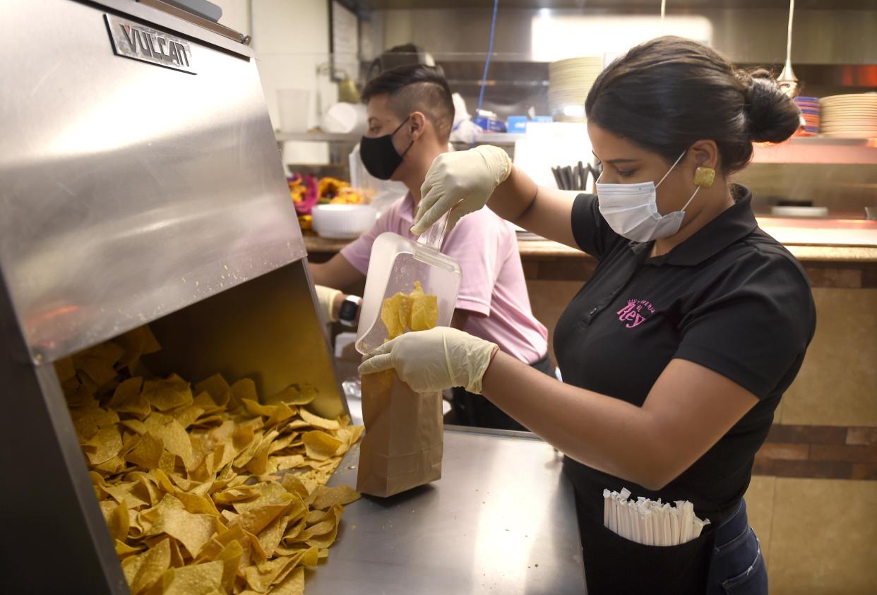 Vanessa Fernandez bags some chips as she assembles lunches at Taqueria El Rey in Martinez, Ga., Thursday morning October 1, 2020.