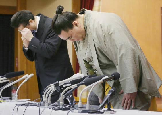 Harumafuj, a Mongolian-born yokozuna, bows to a press conference after announcing his retirement having admitted to assaulting a junior wrestler in 2017 (AFP/Getty Images)