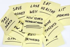 lots of New Year's Resolutions on yellow pieces of paper