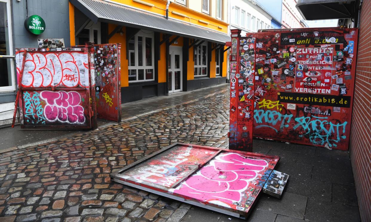 <span>The metal gates at Herbertstraße in Hamburg, affixed with signs barring women and under-18s, block out prying eyes and feature on countless Instagram feeds.</span><span>Photograph: Patrik Stollarz/AFP/Getty Images</span>