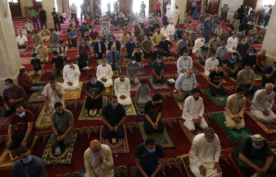 Palestinian worshippers wear protective face mask as they pray the last Friday prayer of the holy fasting month of Ramadan, to prevent the spread of coronavirus pandemic, at al-Hasaynih beach mosque in Gaza City, Friday, May 22, 2020. Palestinian worshippers filled Gaza's mosques as they opened for the central Friday prayers after nearly two months of closure due to the coronavirus threat. (AP Photo/Adel Hana)
