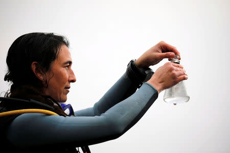 Israeli researcher Gal Vered holds a laboratory flask containing water from the Red Sea as part of research work an Israeli team is conducting using sea squirts in the Israeli resort city of Eilat February 7, 2019. REUTERS/Amir Cohen