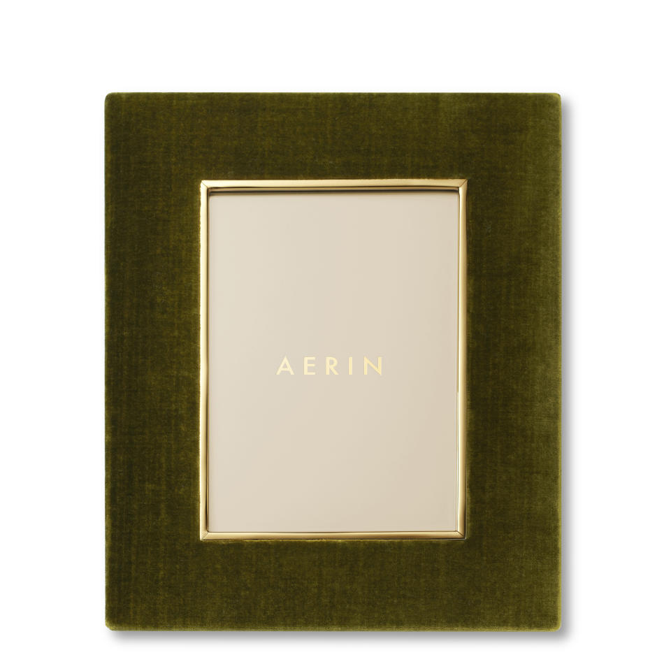 This image provided by Aerin shows a velvet picture frame. Women's Wear Daily raved about Armani dresses in the material. Harper's Bazaar called it one of 2022's biggest trends. At Britain's film awards this year, celebrities partied in Vuitton, Lauren and Gucci versions. It's even found its way down to casual wear, in jeans, T-shirts and slouchy overshirts. Once the luxurious material of nobility, velvet's now a fashion favorite at both the private-label and mass-market level. (Aerin via AP)