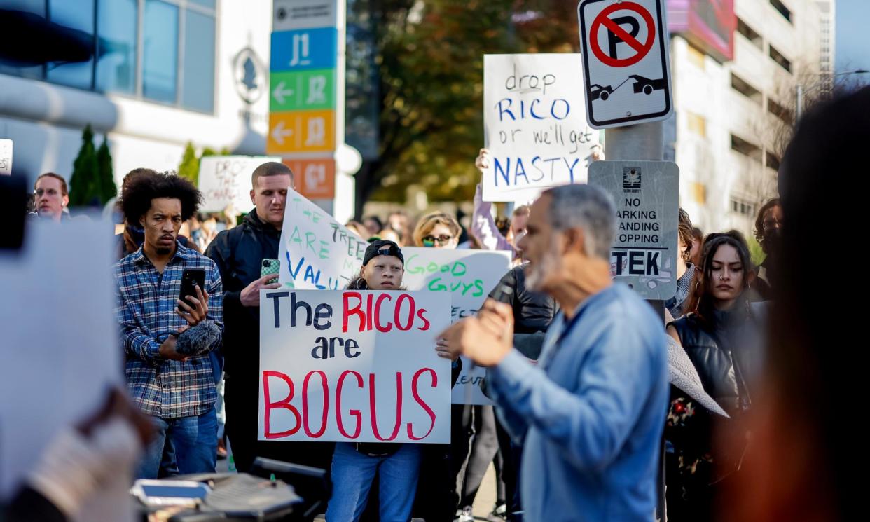 <span>Demonstrators protest outside the Fulton county courthouse as 61 people are arraigned on state Rico charges in Atlanta, Georgia, on 6 November 2023.</span><span>Photograph: Erik S Lesser/EPA</span>