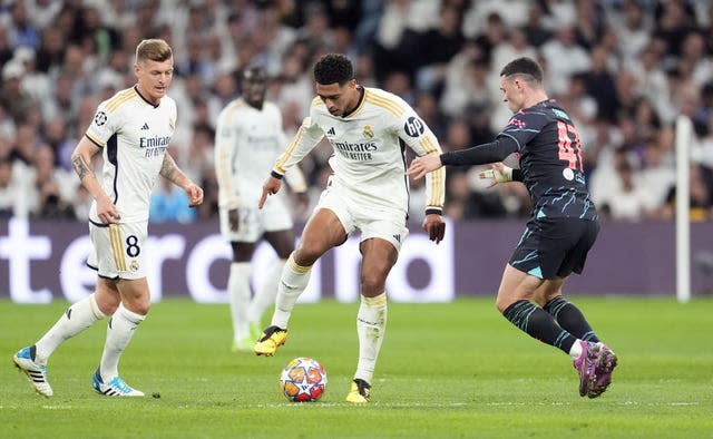 Real Madrid’s Jude Bellingham and Manchester City’s Phil Foden (right) battle for the ball