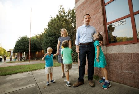 Dan McCready, Democratic candidate in the special election for North Carolina's 9th Congressional District, and his family wait to greet voters outside a polling station on election day, in Charlotte, North Carolina