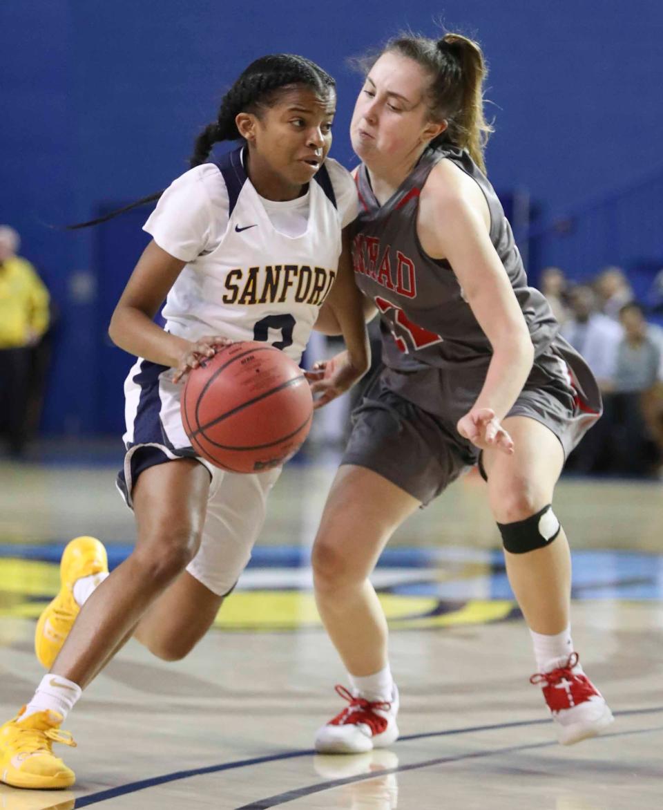 Sanford's Lauren Park (left) drives against Conrad's Alyssa Faville in the first half of a DIAA state tournament semifinal at the Bob Carpenter Center in 2019.