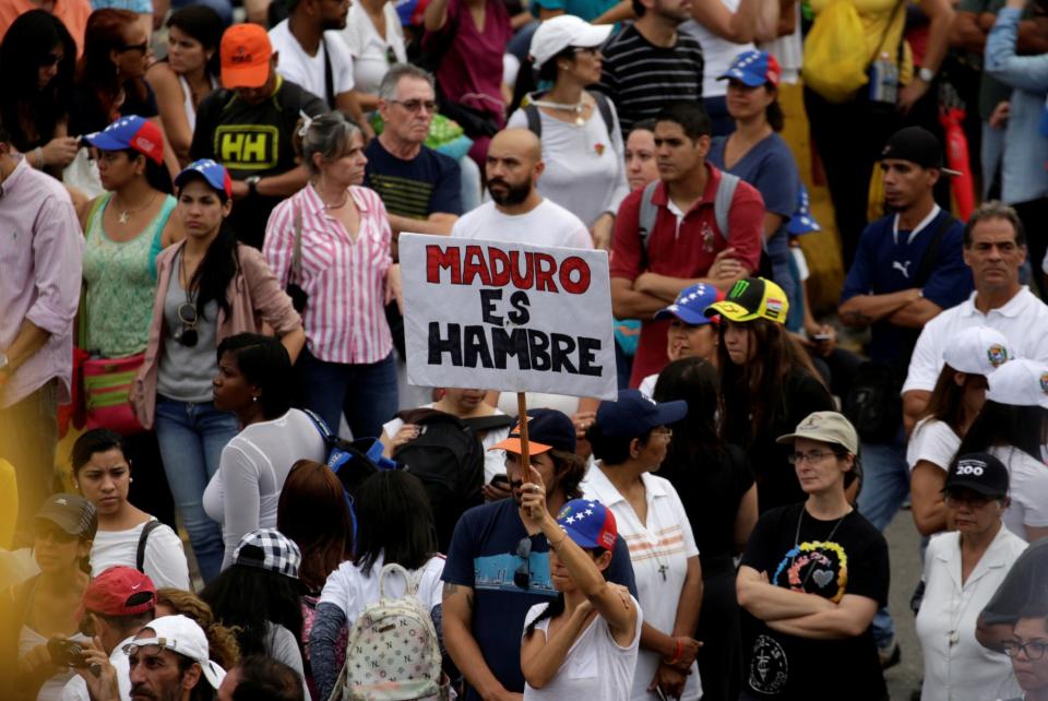 <p>Opposition supporters block an avenue while rallying against President Nicolas Maduro carrying a sign that reads “Maduro is hunger” in Caracas, Venezuela, May 15, 2017. (REUTERS/Marco Bello/Reuters) </p>