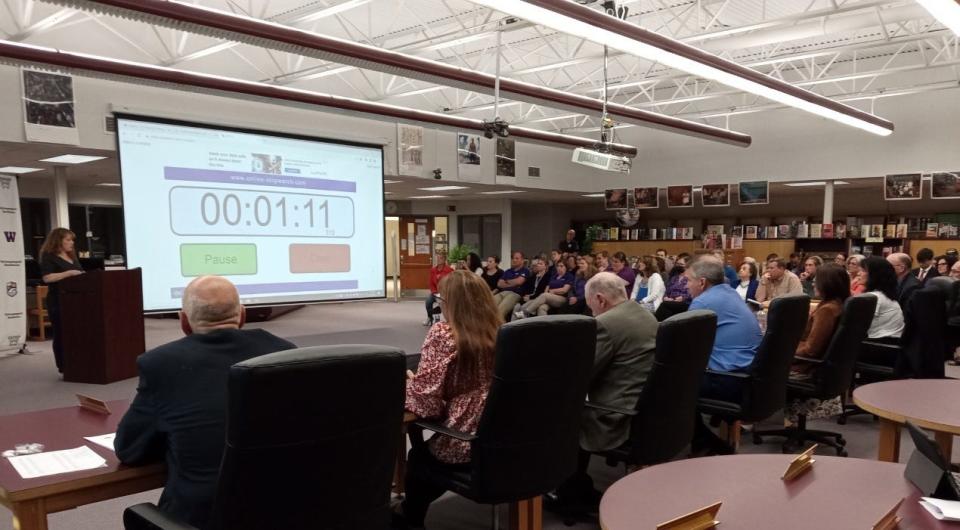 Maria Rotella addresses the Wallenpaupack School Board, May 15 in the high school library, with concerns about five of the books available there for students. The board allowed five minutes for each speaker rather than the usual three, the time being counted down on the screen.