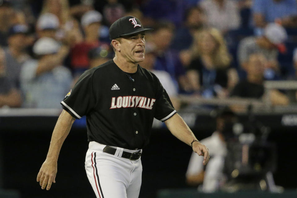 FILE - In this June 21, 2019, file photo, Louisville coach Dan McDonnell walks to the mound in the ninth inning of an NCAA College World Series baseball game against Vanderbilt in Omaha, Neb. Louisville is ranked No. 1 in the preseason in three polls. The Cardinals have reached the College World Series four times since 2013 and five times overall, and their 605 wins since 2007 are most in the nation. (AP Photo/Nati Harnik, File)