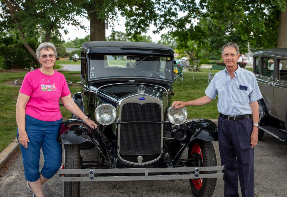 Mary and Mick Krueger take a moment to pose for a photo near their Ford Model A car.