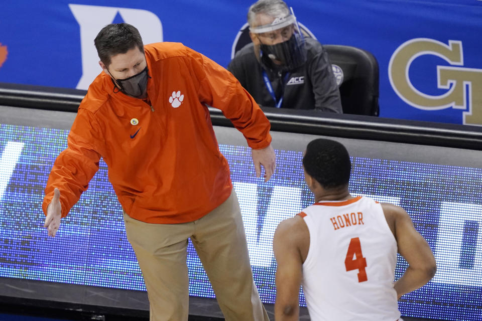 Clemson head coach Brad Brownwell greets guard Nick Honor (4) during the second half of an NCAA college basketball game in the second round of the Atlantic Coast Conference tournament in Greensboro, N.C., Wednesday, March 10, 2021. (AP Photo/Gerry Broome)