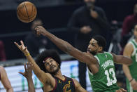Boston Celtics' Tristan Thompson, right, and Cleveland Cavaliers' Jarrett Allen watch the ball during the first half of an NBA basketball game Wednesday, May 12, 2021, in Cleveland. (AP Photo/Tony Dejak)