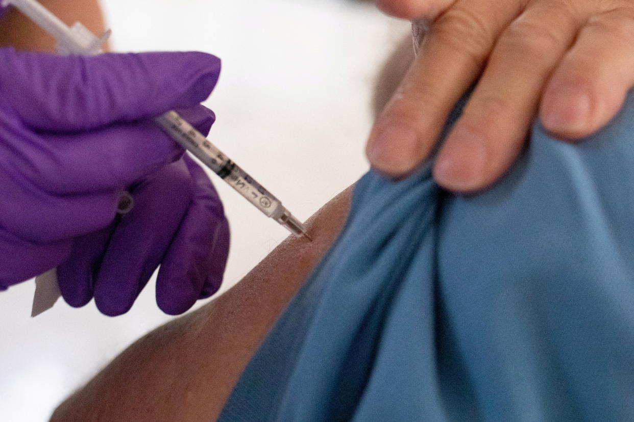 A man receives a second booster shot of the COVID-19 vaccine.