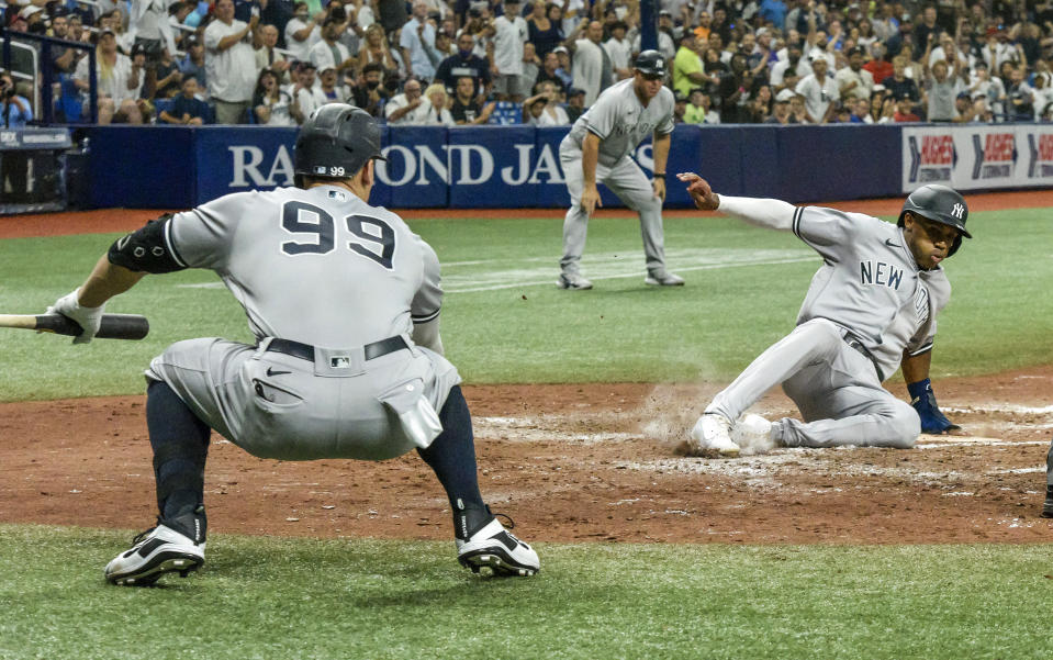 New York Yankees' Aaron Judge (99) watches as Greg Allen, right, scores on a DJ LeMahieu's RBI single off Tampa Bay Rays starter Shane McClanahan during the fifth inning of a baseball game Tuesday, July 27, 2021, in St. Petersburg, Fla. (AP Photo/Steve Nesius)